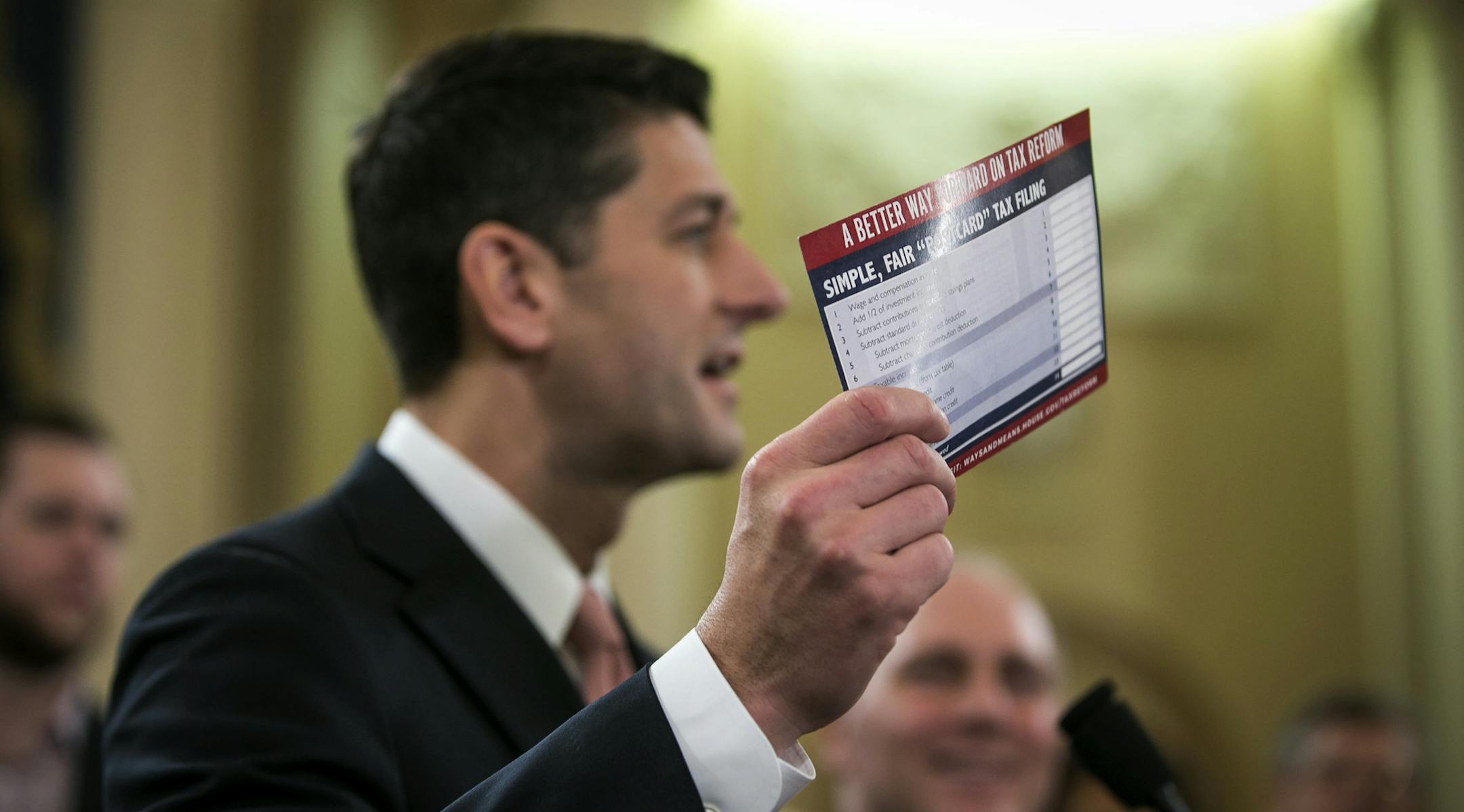 House Speaker Paul Ryan (R-Wis.), accompanied by other Republican legislators, holds up an example of what a "postcard" tax return might look like during a news conference to unveil a tax reform plan, on Capitol Hill in Washington, Nov. 2, 2017. The proposal does not target the so-called carried-interest provision of the tax code. (Al Drago/The New York Times)
