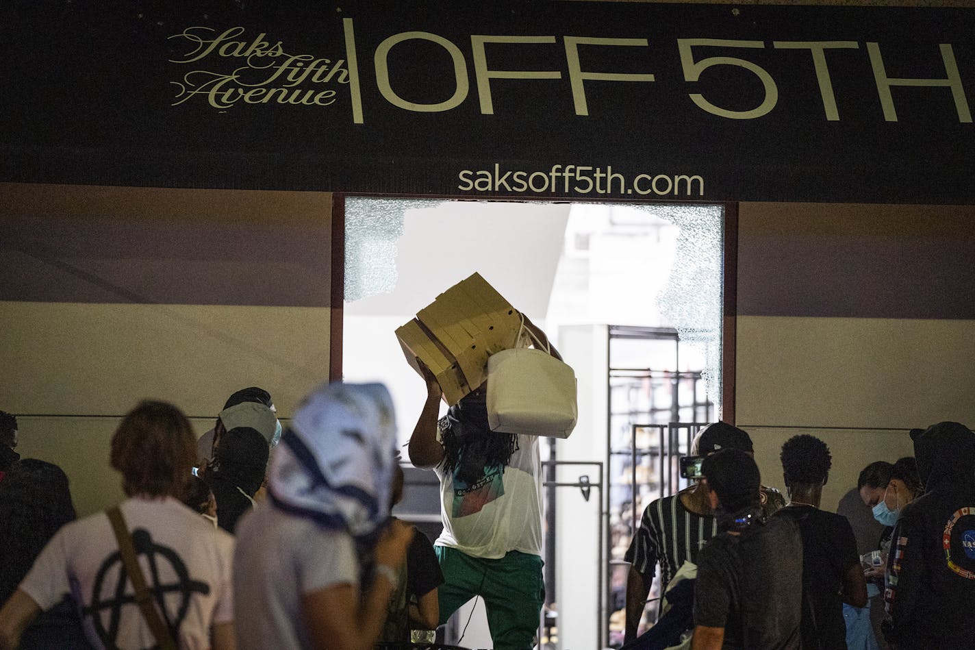 Crowds looted the Saks Off Fifth store in downtown Minneapolis on Wednesday, Aug. 26, after rumors swirled that police had shot a man, when in fact the man had killed himself.