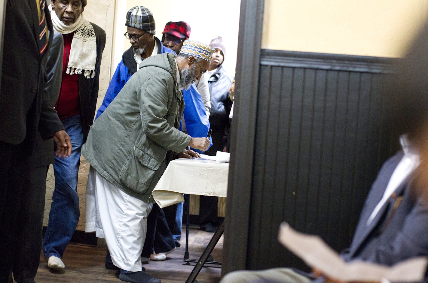 Community members created name tags as they entered the meeting at the Islamic Civic Society of America headquarters in the Cedar-Riverside neighborhood.