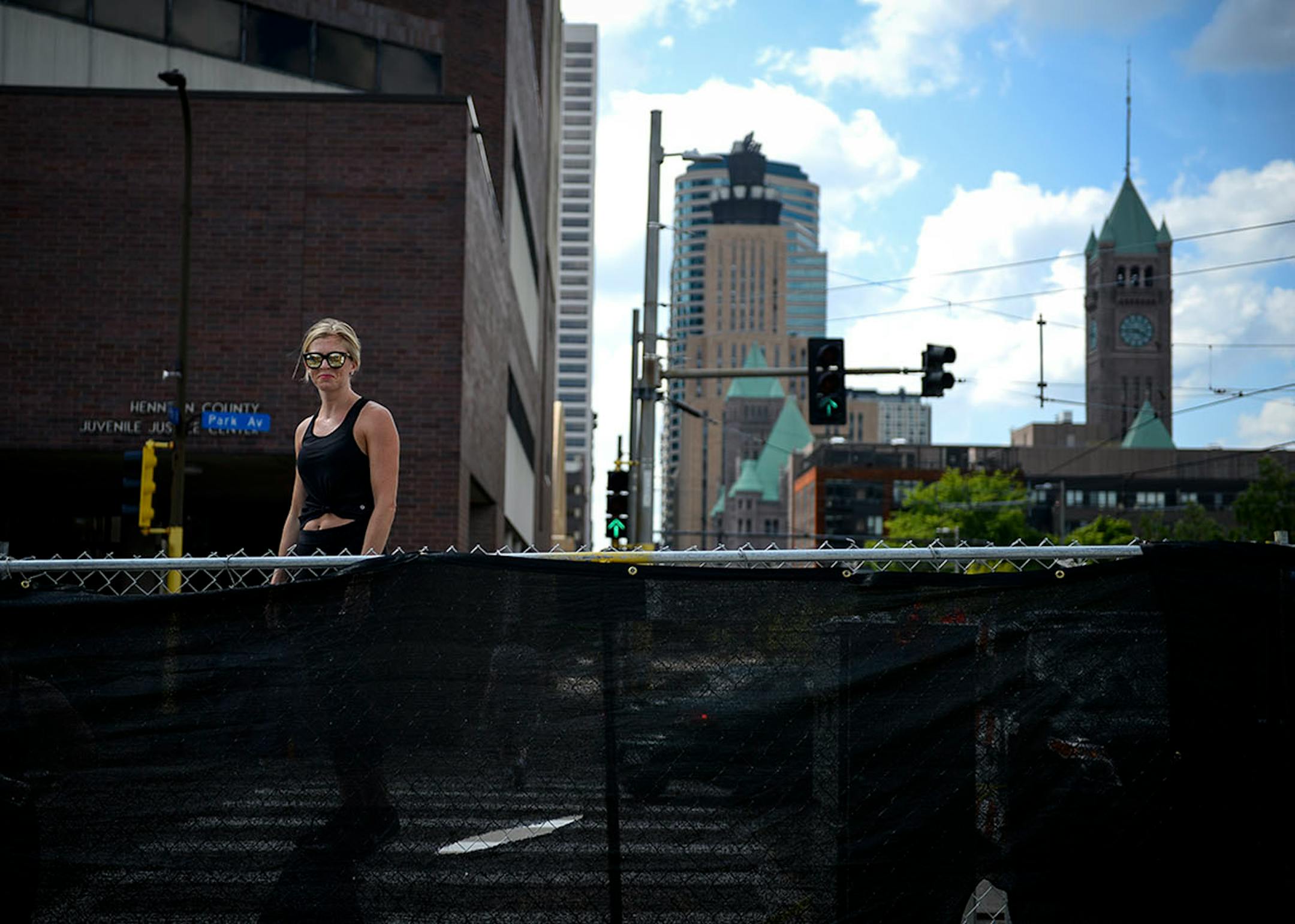 Molly McElroy, of Minneapolis, pouted as she was forced to watch some of X Fest's happenings while standing atop a concrete barrier due to a barrier blocking the Commons from public view.