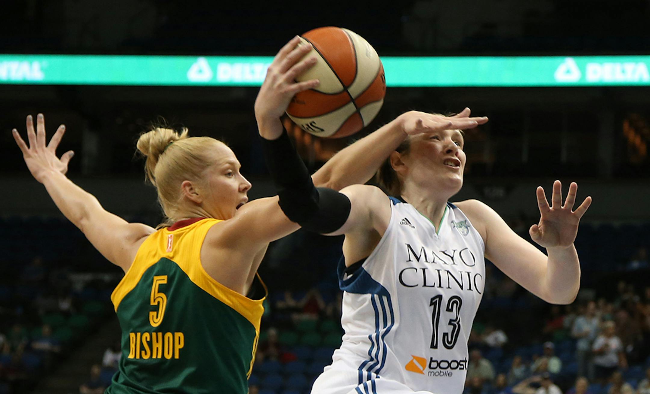 Lynx Lindsay Whalen got fouled by Seattle's Abby Bishop on her way to the basket during the first half.