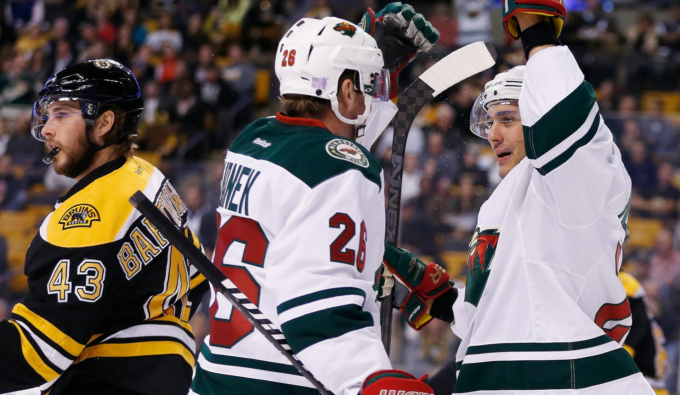 Minnesota Wild right wing Nino Niederreiter (22), of Switzerland, celebrates his goal with teammate Thomas Vanek (26) in the first period of an NHL hockey game against the Boston Bruins in Boston, Tuesday, Oct. 28, 2014. (AP Photo/Michael Dwyer)