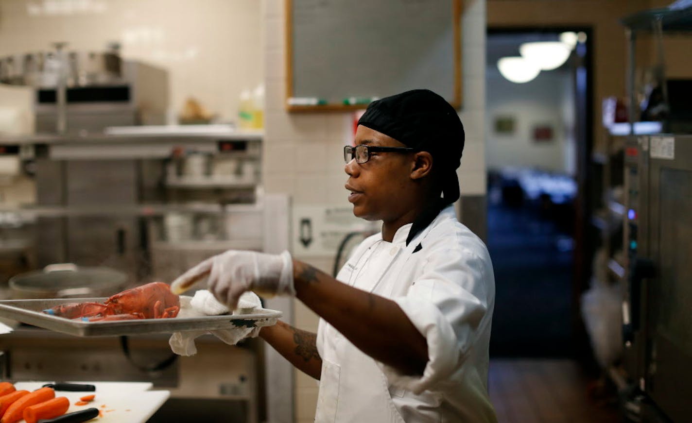 Patrice Jimerson carried a lobster from the steamer during a class at St. Paul College, where there is often a waiting list to get in.