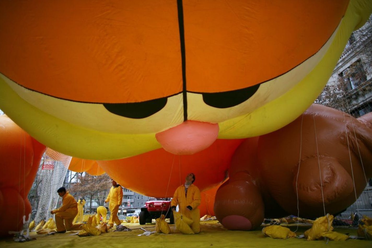 James Muscianesi, center, and fellow members of the Macy's Thanksgiving Parade Inflation Team, prepare Garfield for Thursday's parade, in New York's Upper Westside, Wednesday, Nov. 22, 2006. Garfield will join several other giant, helium-filled cartoon characters as part of the annual parade down Broadway on Thursday.