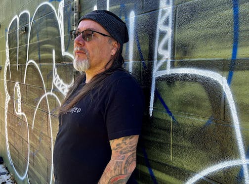 photo of author Theodore C. Van Alst. Jr. in front of Chicago graffiti