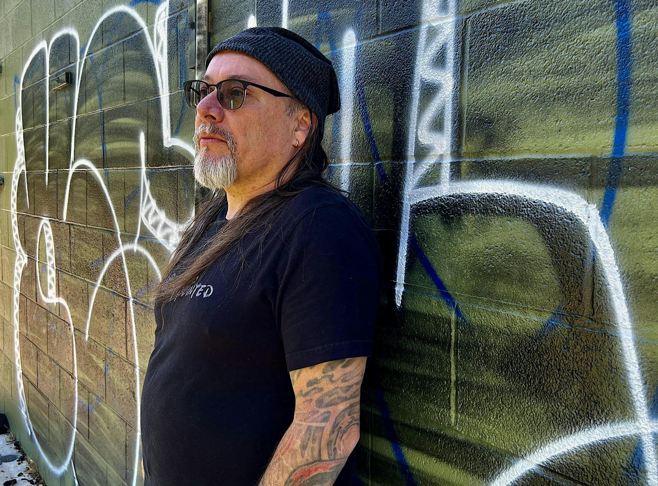 photo of author Theodore C. Van Alst. Jr. in front of Chicago graffiti