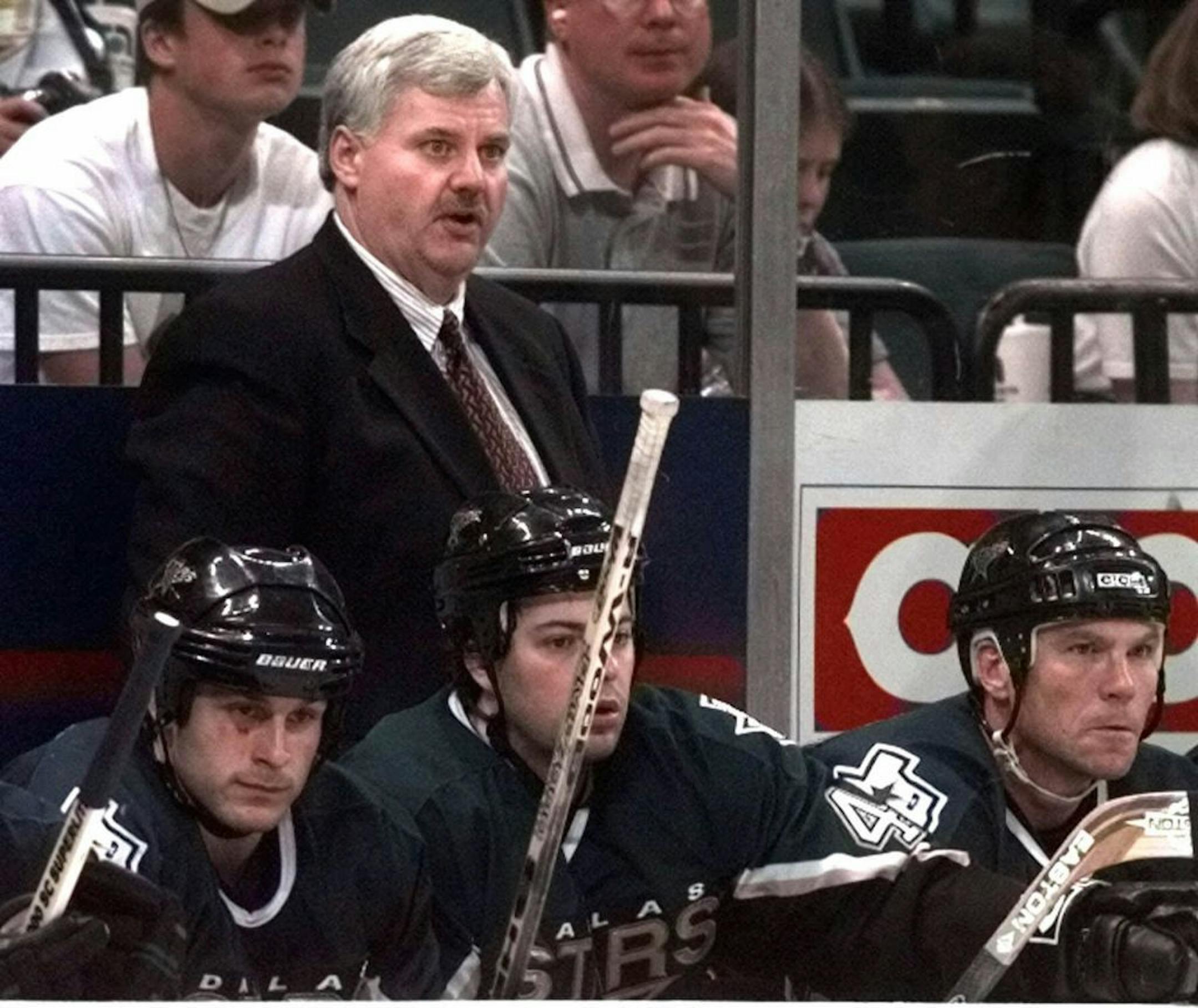 Dallas Stars coach Ken Hitchcock watches behind the bench during the second period against the Los Angeles Kings in Dallas, Sunday, April 11, 1999. The Stars beat the Kings 6-2.