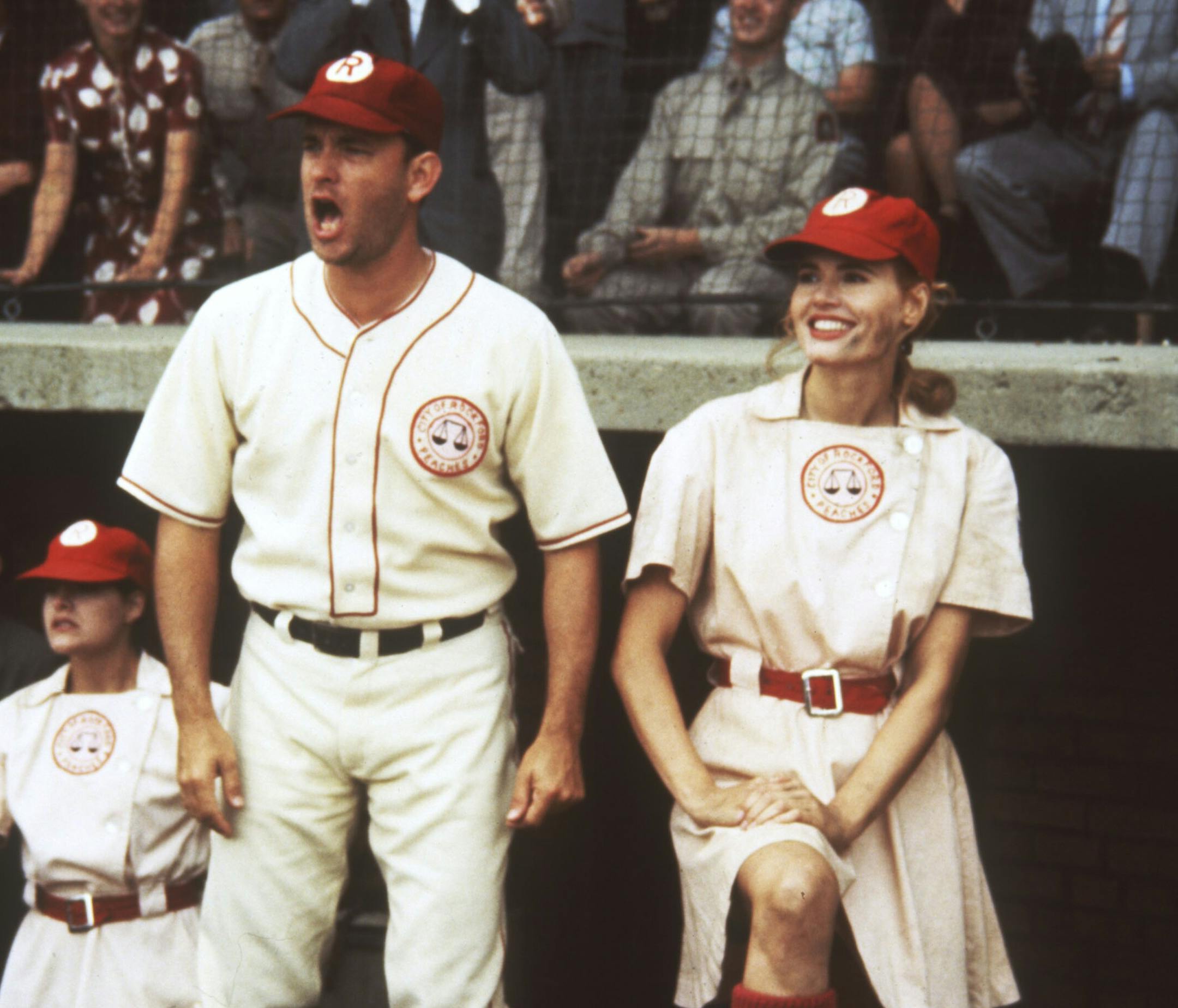 "A League of Their Own"1992 baseball movie from Columbia Pictures. Jimmy Dugan (played by Tom Hanks, center), manager of the Rockford Peaches, and Dottie Hinson (Geena Davis, right), his catcher and top player, root for their team. Handout photo.