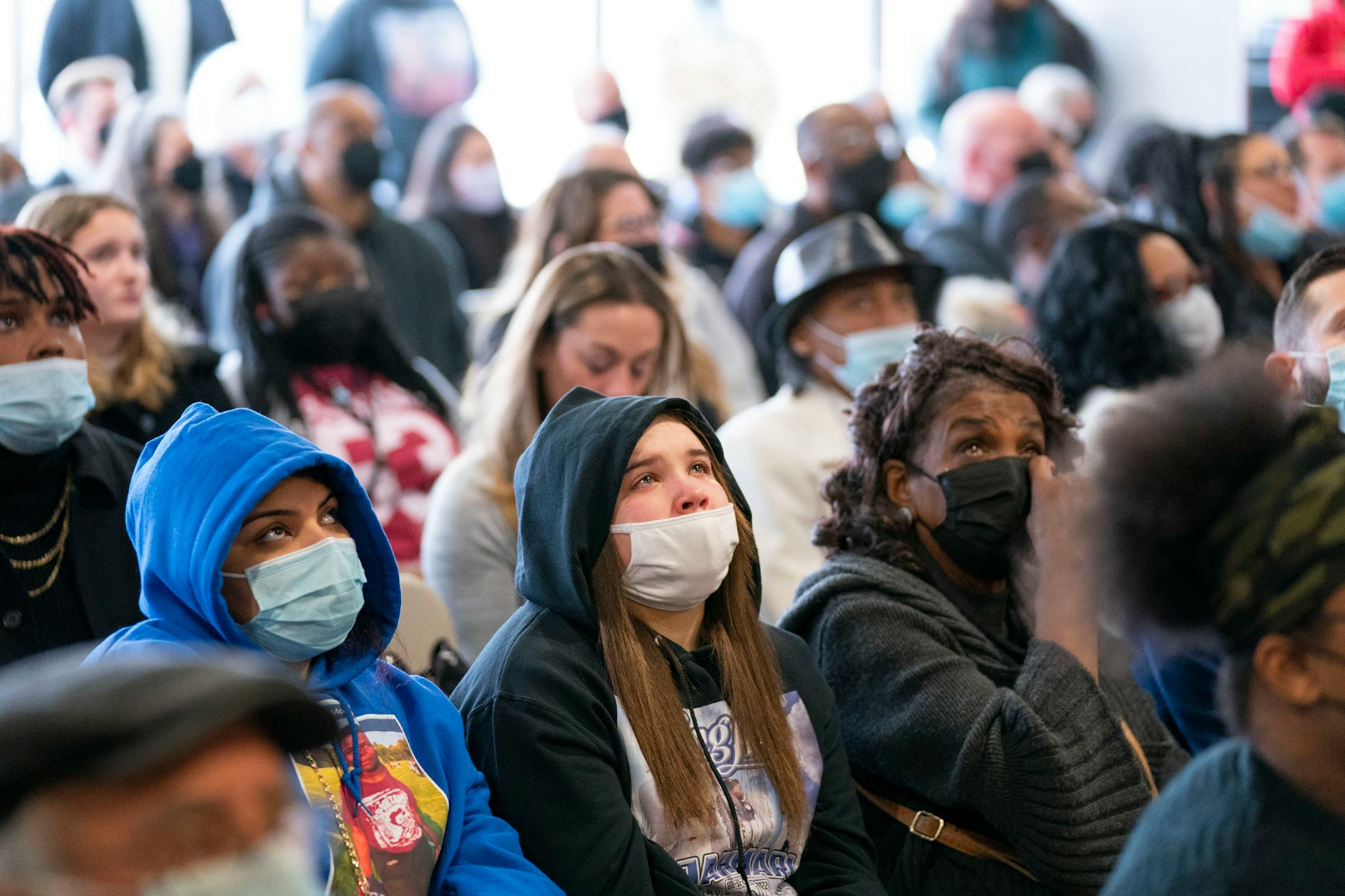 Mourners watch a slideshow presentation at Jahmari Rice's funeral Wednesday, Feb. 9, 2022 at Hope Presbyterian Church in Richfield.