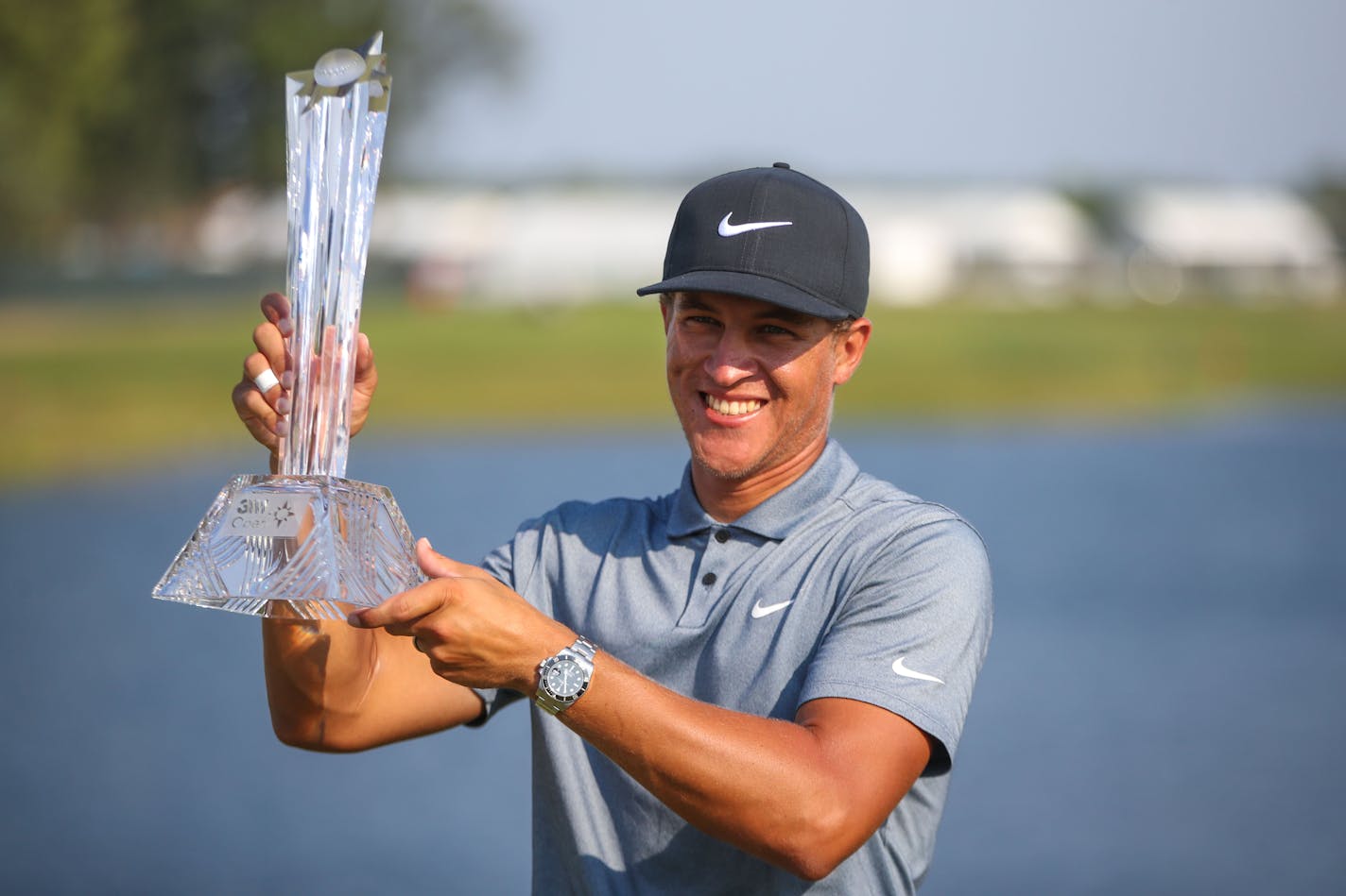 Cameron Champ lifts the trophy at the 3M Open at TPC Twin Cities on Sunday, July 25, 2021 in Blaine. ] ANTRANIK TAVITIAN • anto.tavitian@startribune.com