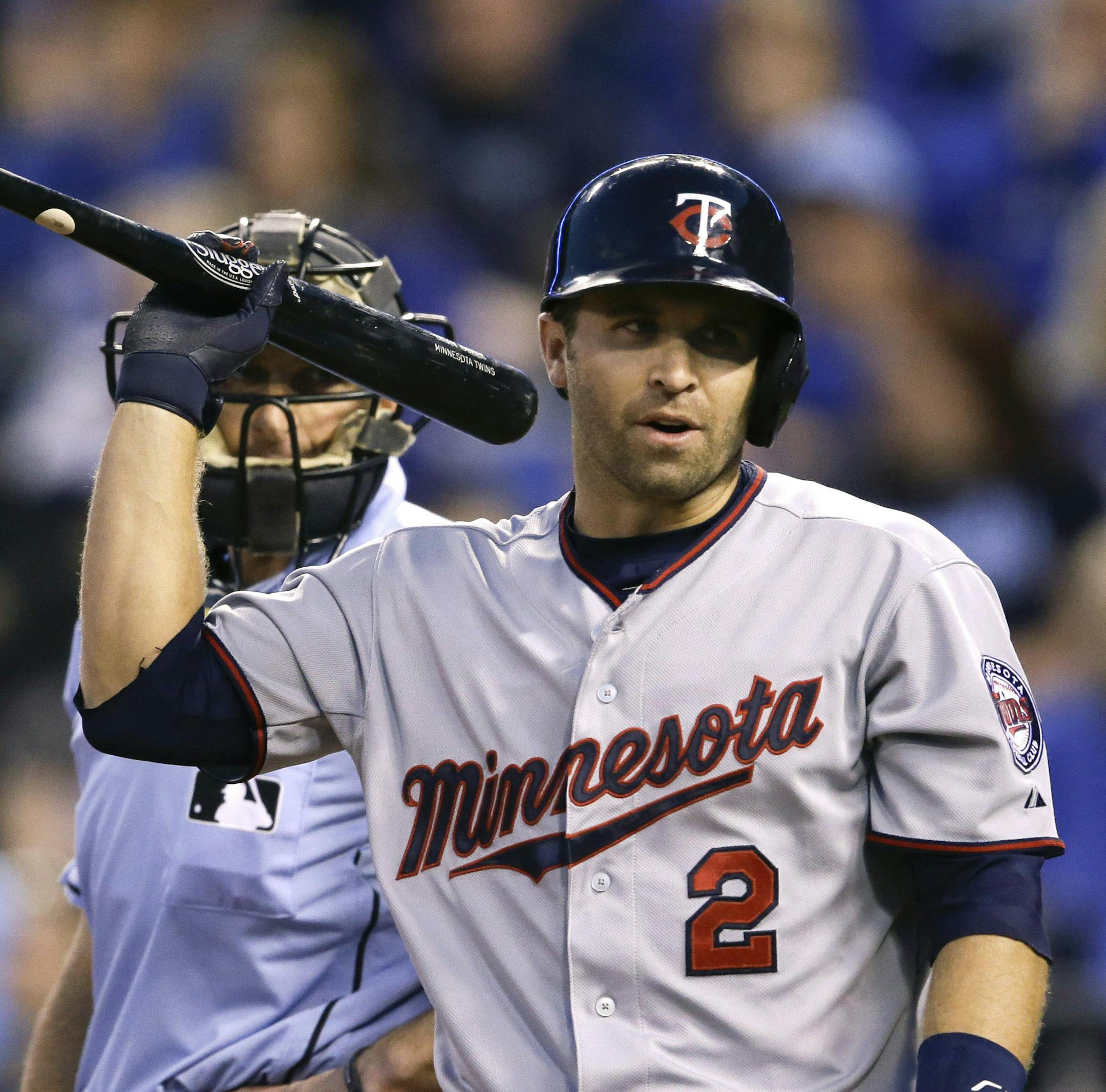 Minnesota Twins' Brian Dozier (2) flips his bat after striking out on a called third strike during the fourth inning of a baseball game against the Kansas City Royals at Kauffman Stadium in Kansas City, Mo., Tuesday, April 21, 2015. (AP Photo/Orlin Wagner) ORG XMIT: MIN2015042120363379