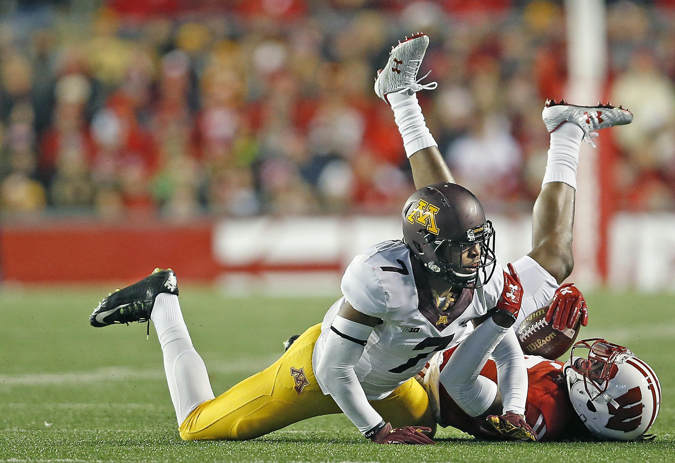 Minnesota's defensive back Damarius Travis tackled Wisconsin's wide receiver Robert Wheelwright in the third quarter as Minnesota took on Wisconsin at Camp Randall Stadium, Saturday, November 26, 2016 in Madison, Wis.