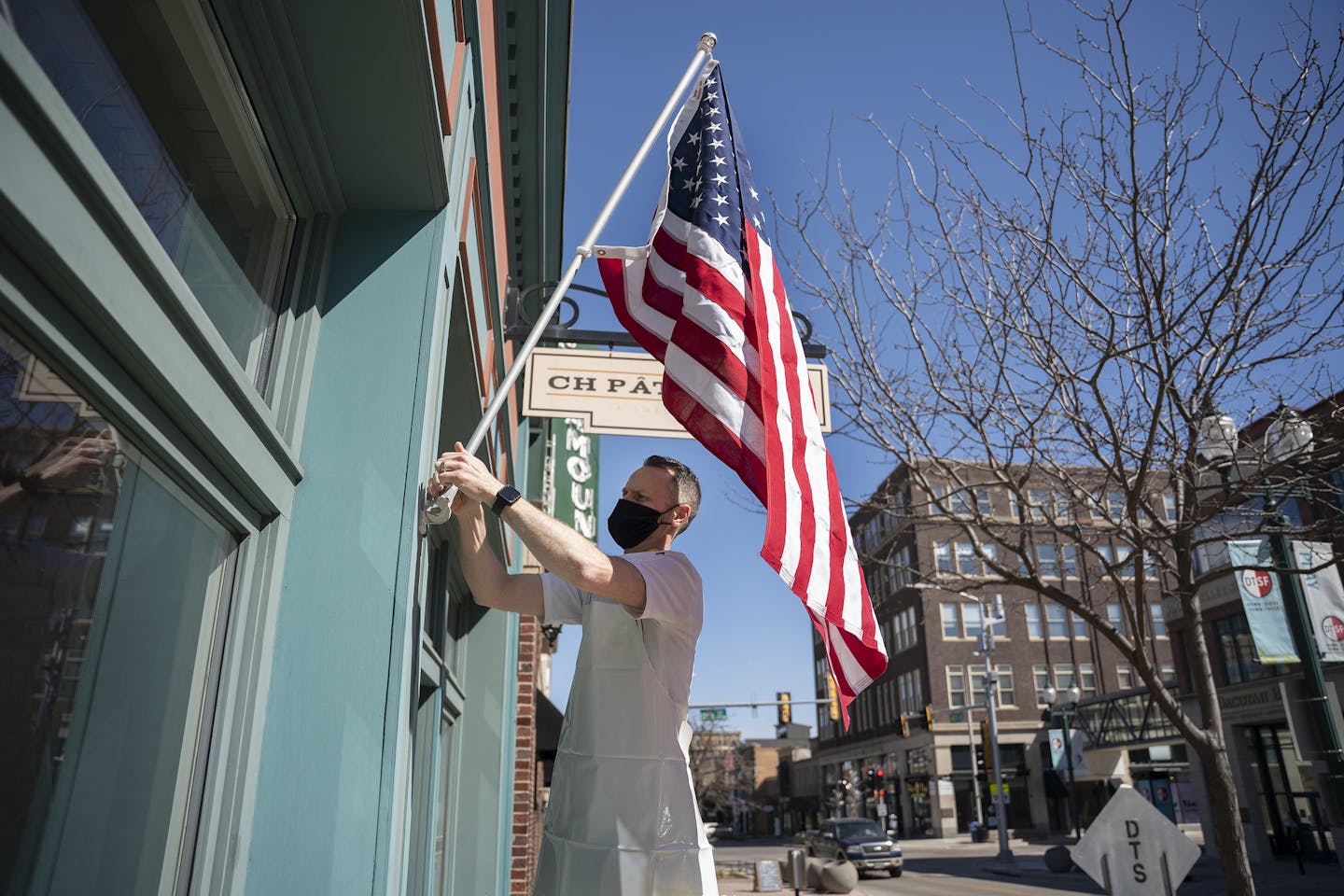 Chris Hanmer, owner of CH Patisserie, in Sioux Falls, S.D. Most bars and restaurants there have voluntarily switched to serving takeout only. But other businesses are open.