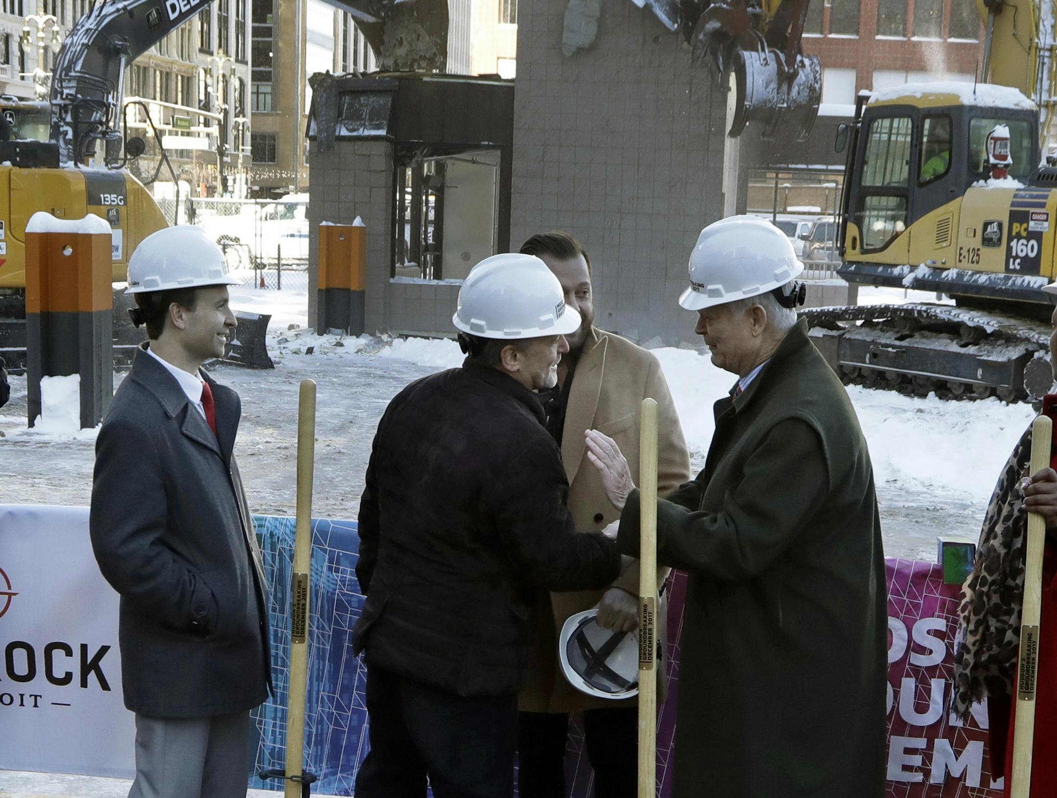 Quicken Loans founder Dan Gilbert, center, meets with Joe Hudson, former CEO of the J.L. Hudson Company at the groundbreaking site of the city's new 800-foot-tall building, Thursday, Dec. 14, 2017, in Detroit. Bedrock Detroit real estate says the $900 million two-building project will include a 58-story residential tower and 12-floor building for retail and conference space. The tower will have an 800-foot-tall (244-meter) sky deck.(AP Photo/Carlos Osorio)