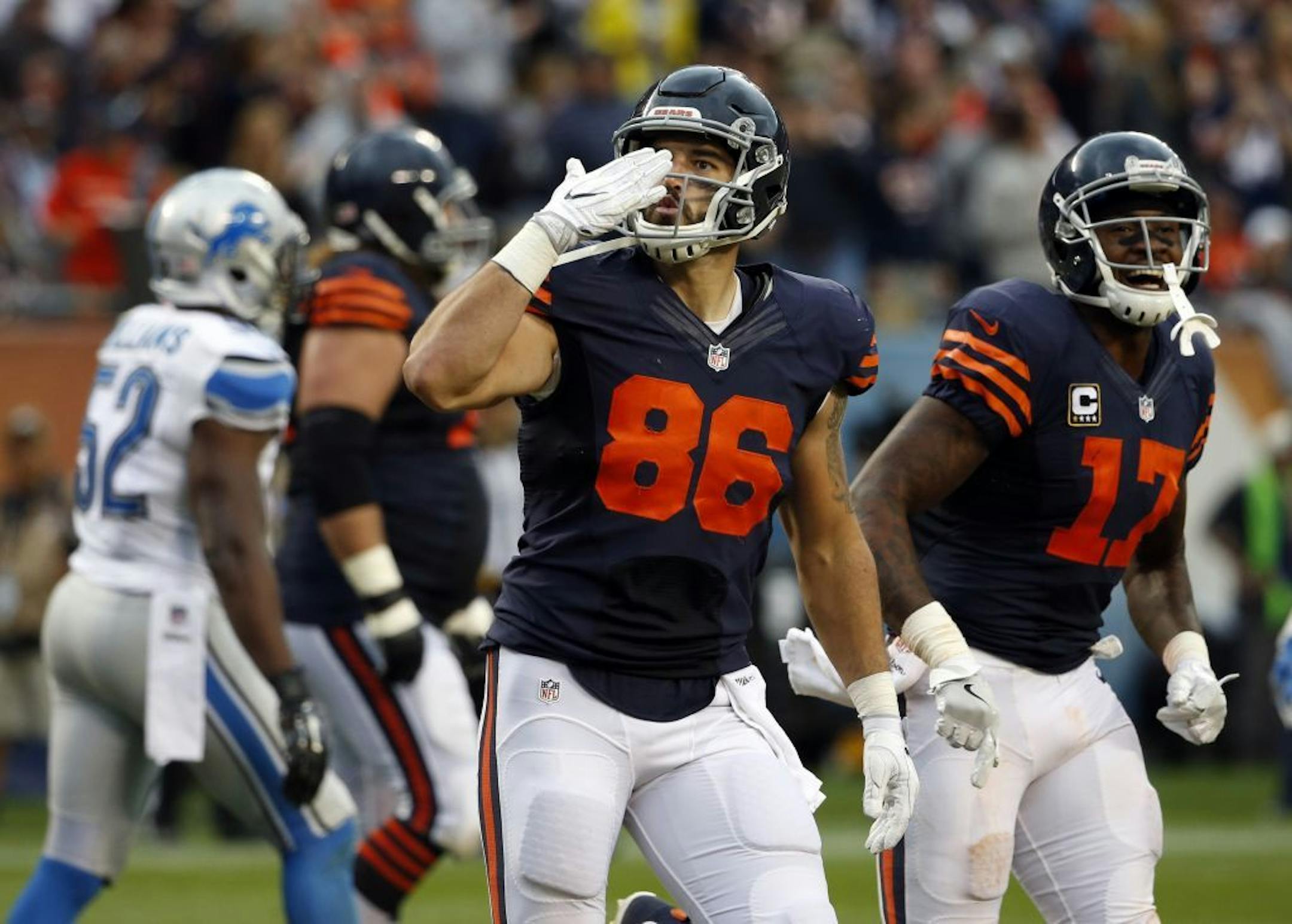 Chicago Bears tight end Zach Miller (86) blows a kiss as he celebrates a touchdown during the second half of an NFL football game against the Detroit Lions, Sunday, Oct. 2, 2016, in Chicago. At right is Chicago Bears wide receiver Alshon Jeffery (17).