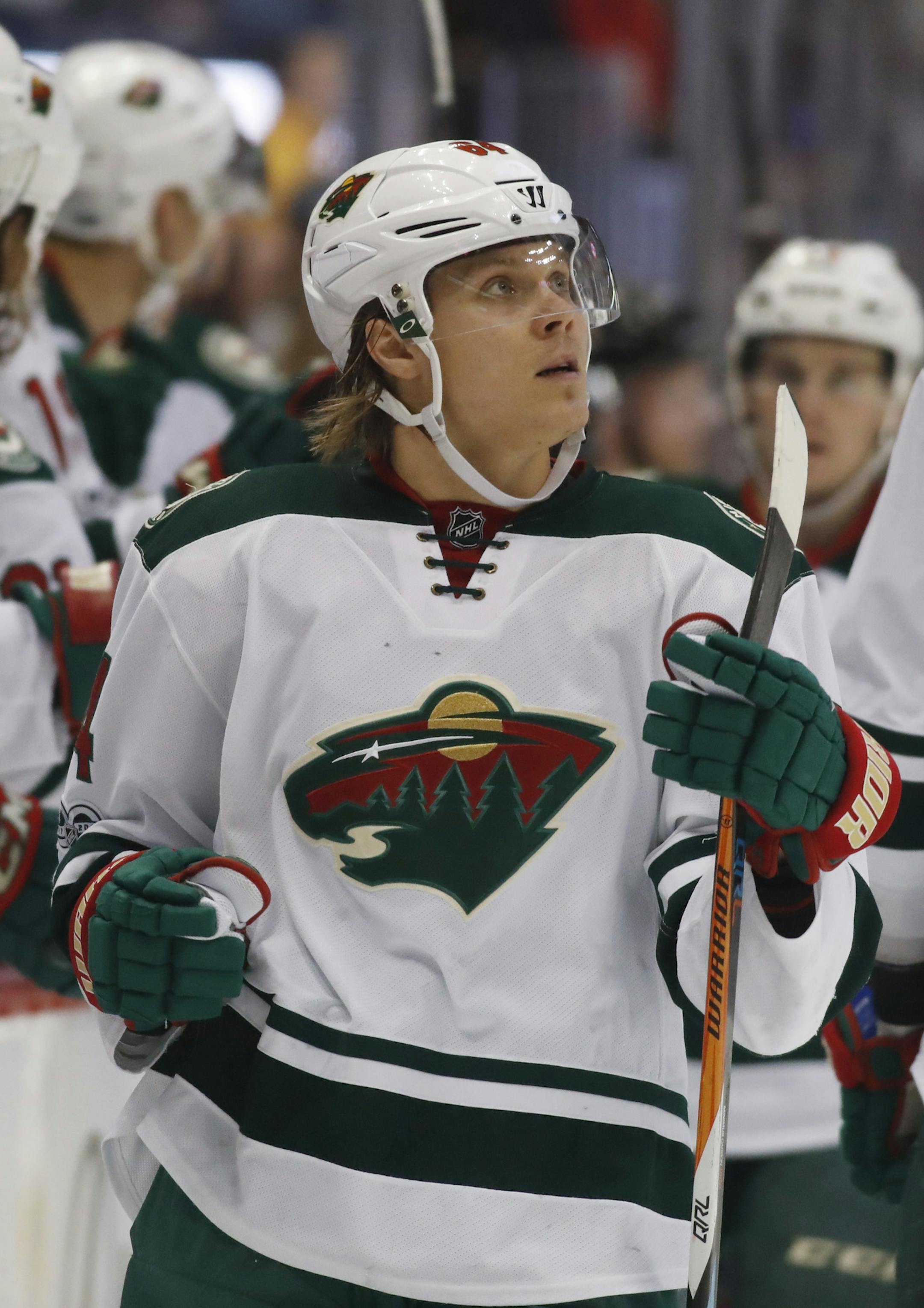 Minnesota Wild center Mikael Granlund, of Finland, is congratulated as he passes the team box after scoring a goal against the Colorado Avalanche during the third period of an NHL hockey game Thursday, April 6, 2017, in Denver. Minnesota won 4-3. (AP Photo/David Zalubowski) ORG XMIT: MIN2017040816100192