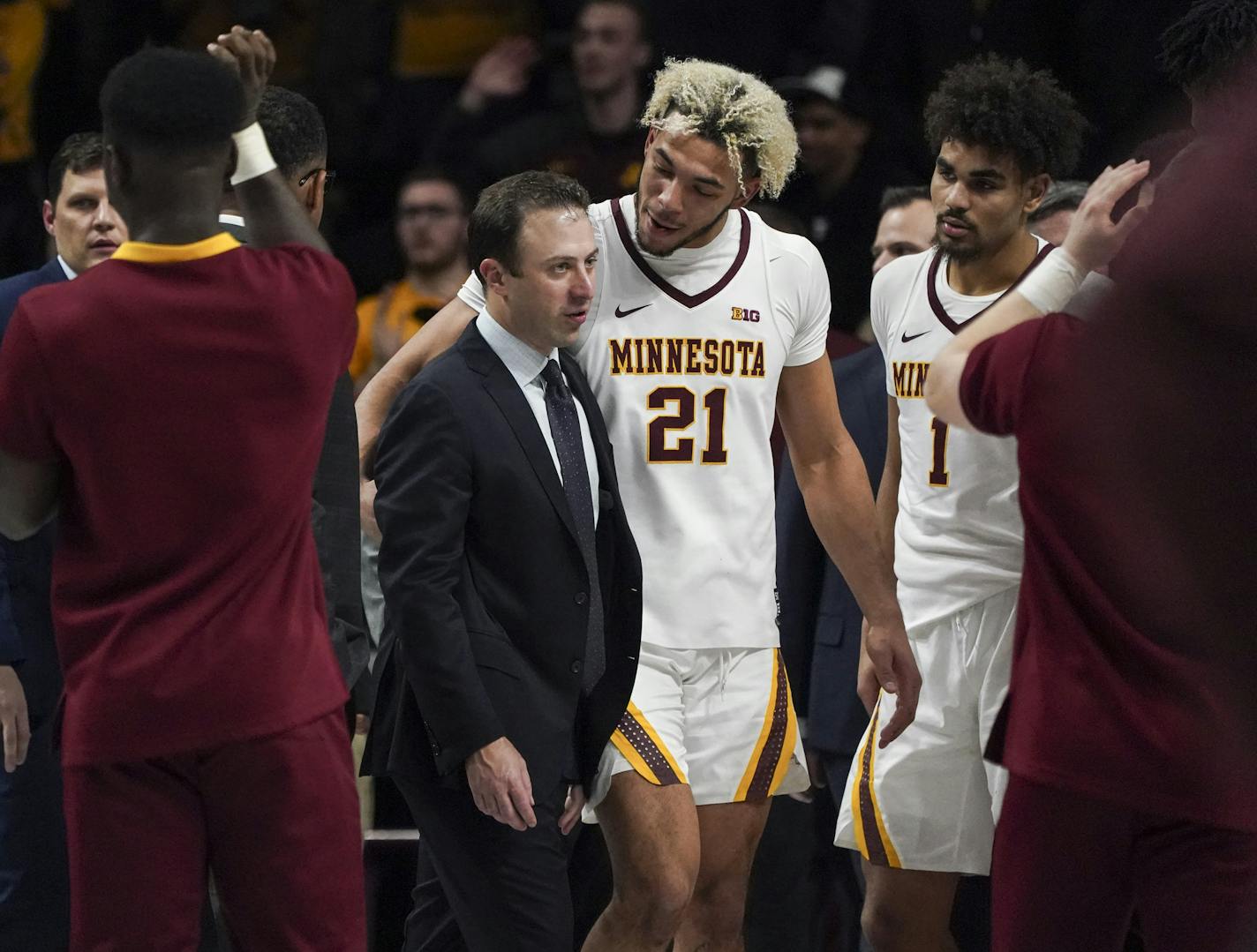 Gophers forward Jarvis Omersa (21) talked with head coach Richard Pitino at the end of the team's win against Penn State at Williams Arena on Jan. 15.