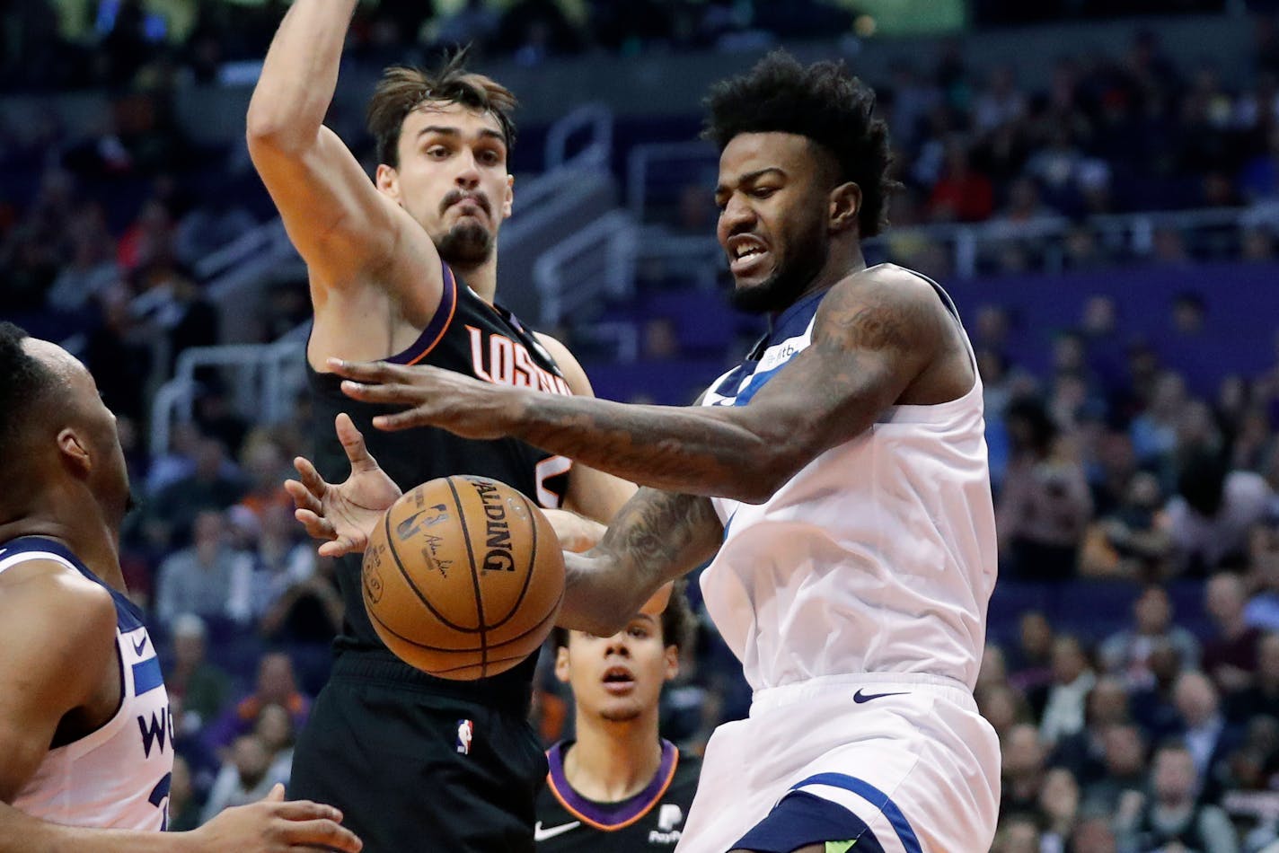 Minnesota Timberwolves forward Jordan Bell, right, loses the ball as Phoenix Suns forward Dario Saric defends during the first half of an NBA basketball game, Monday, Dec. 9, 2019, in Phoenix. (AP Photo/Matt York)