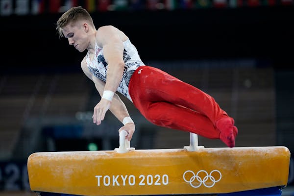 Shane Wiskus performs on the pommel horse Saturday during the men’s gymnastic qualifications.