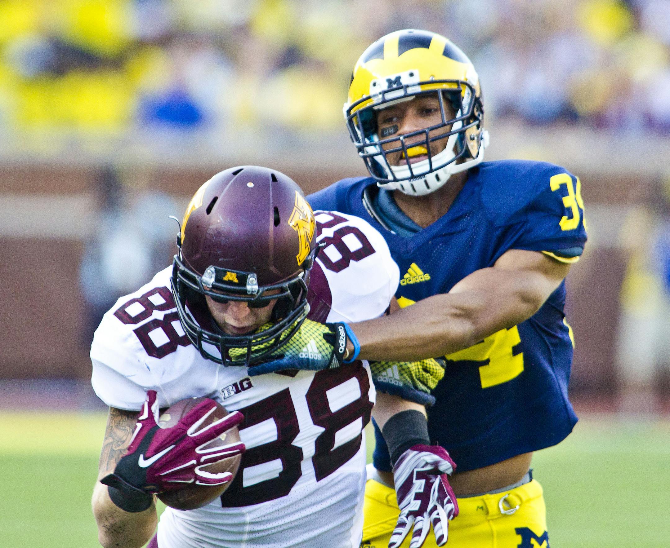 Minnesota tight end Maxx Williams (88) makes a one-handed catch while defended by Michigan defensive back Jeremy Clark (34) in the third quarter of an NCAA college football game in Ann Arbor, Mich., Saturday, Sept. 27, 2014. Minnesota won 30-14. (AP Photo/Tony Ding) ORG XMIT: MITD110