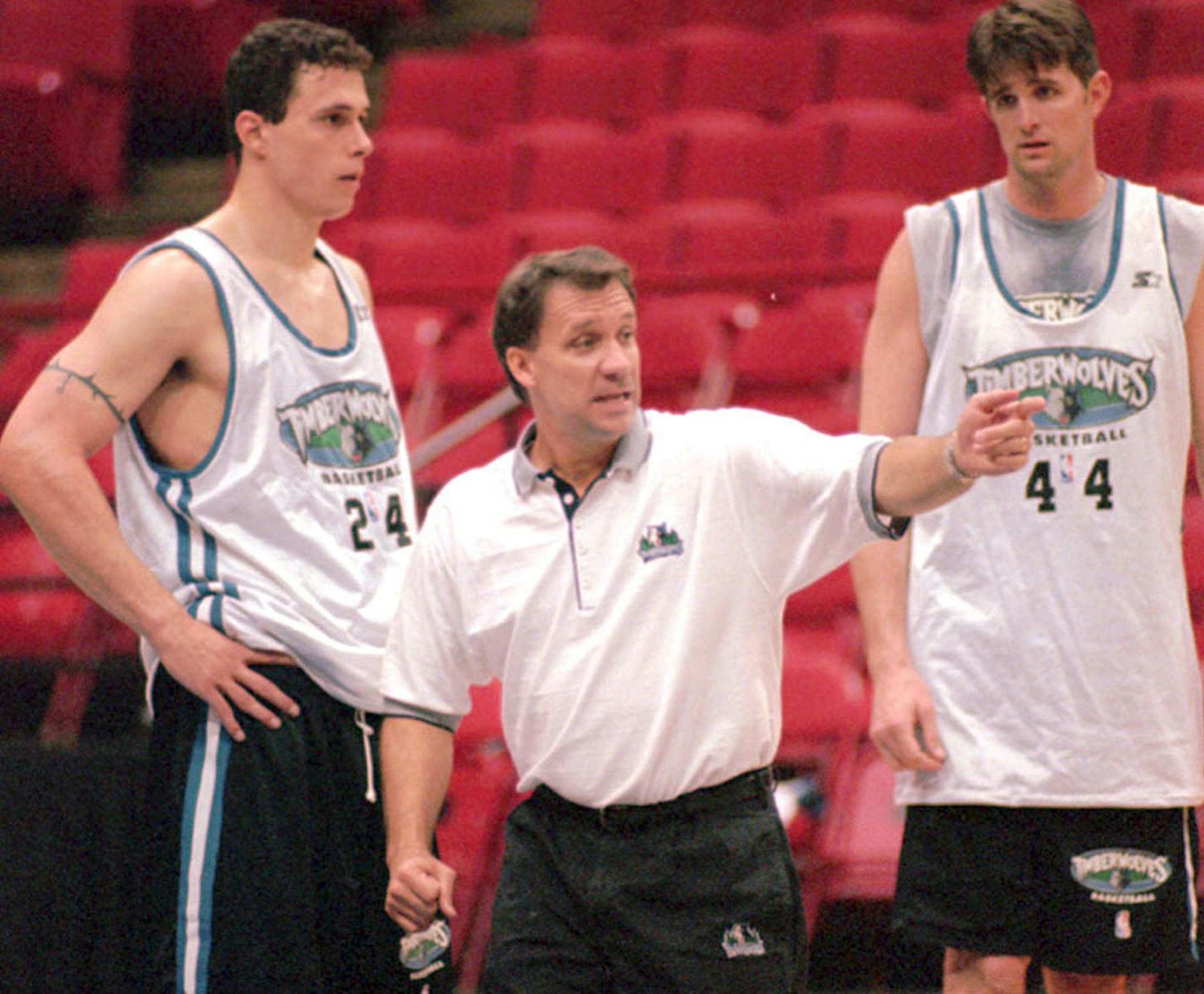 Minnesota Timberwolves coach Flip Saunders explains a drill to his team as forwards Tom Gugliotta (24) and Cherokee Parks (44) listen during training camp in Minneapolis, Friday, Oct. 3, 1997. The uncertainty over Kevin Garnett is over, giving Saunders his first chance to concentrate solely on basketball as training camp opened Friday.
