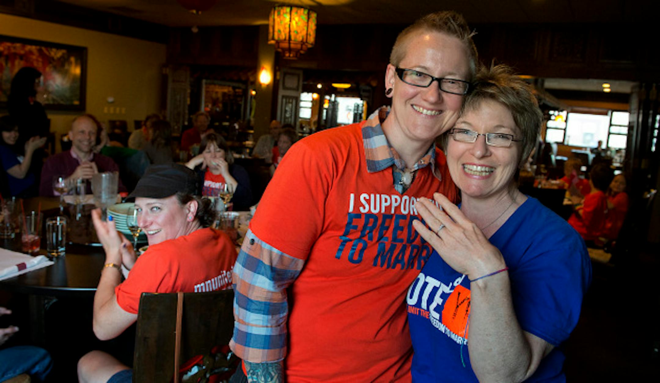 Awen and Kit Briem got engaged in the Minnesota Capitol right after the Senate voted to allow same-sex marriages in Minnesota.  Kit showed off her engagement ring while the couple celebrated their engagement with friends at Mai Village restaurant in St. Paul, a mile away from the Capitol.  Monday, May 13, 2013    ]   GLEN STUBBE * gstubbe@startribune.com