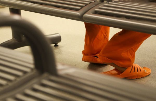 An inmate waits in to be booked and put in the system.