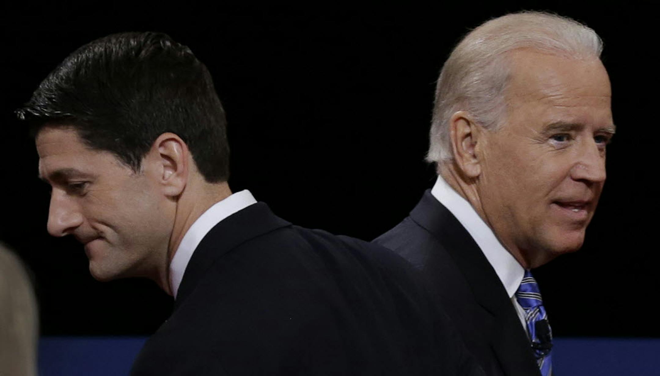 Paul Ryan, left, and Joe Biden pass each other after Thursday's vice presidential debate.