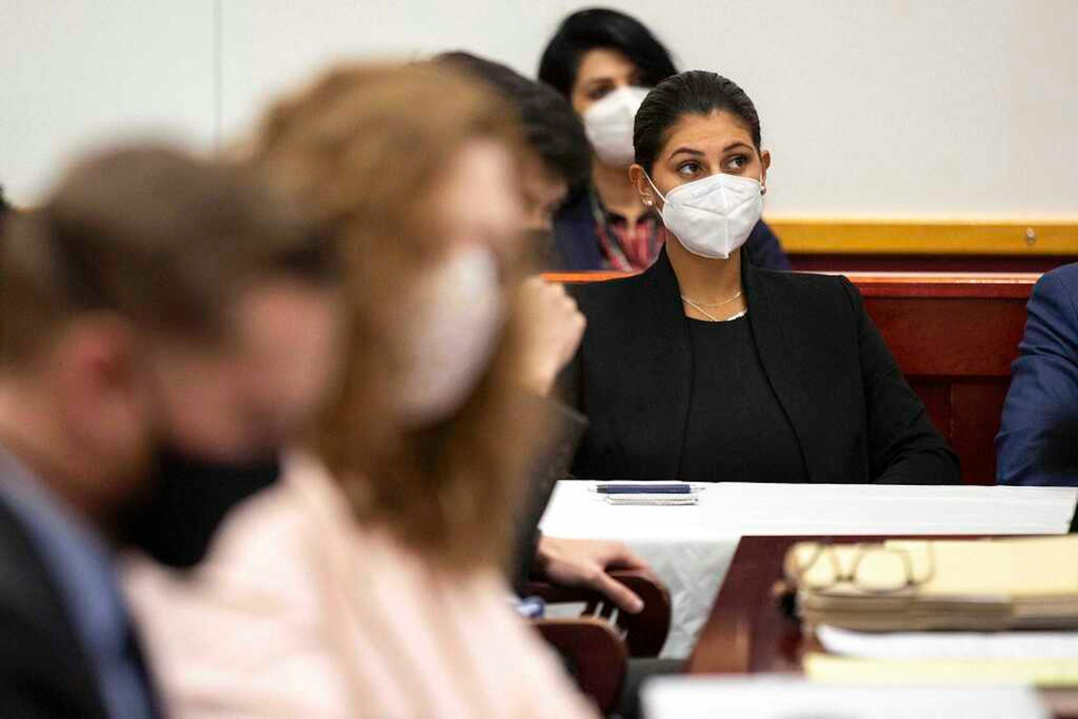 Des Moines Register reporter Andrea Sahouri listens to opening statements in her trial in which she is charged with failure to disperse and interference with official acts while reporting on a protest last summer, Monday, March 8, 2021, at the Drake University Legal Clinic, in Des Moines, Iowa. (Kelsey Kremer/The Des Moines Register via AP)