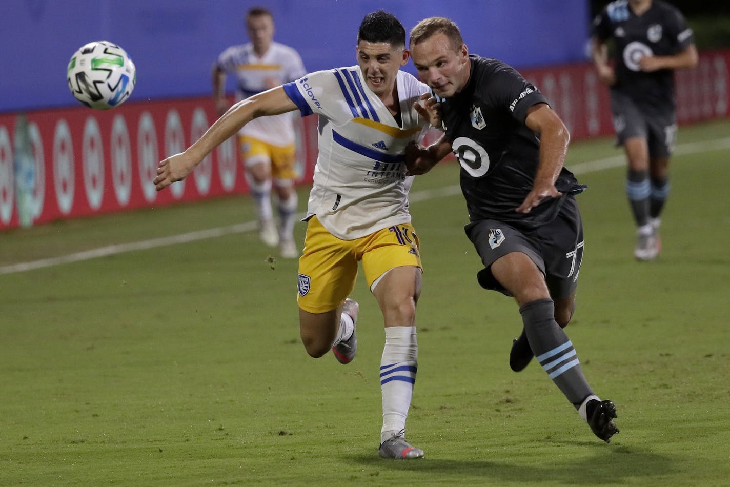 San Jose Earthquakes forward Cristian Espinoza, left, and Minnesota United defender Chase Gasper vie for the ball during the first half of an MLS soccer match, Saturday, Aug. 1, 2020, in Kissimmee, Fla. (AP Photo/John Raoux)