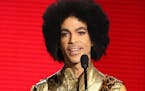 In this Nov. 22, 2015 file photo, Prince presents the award for favorite album - soul/R&B at the American Music Awards in Los Angeles.