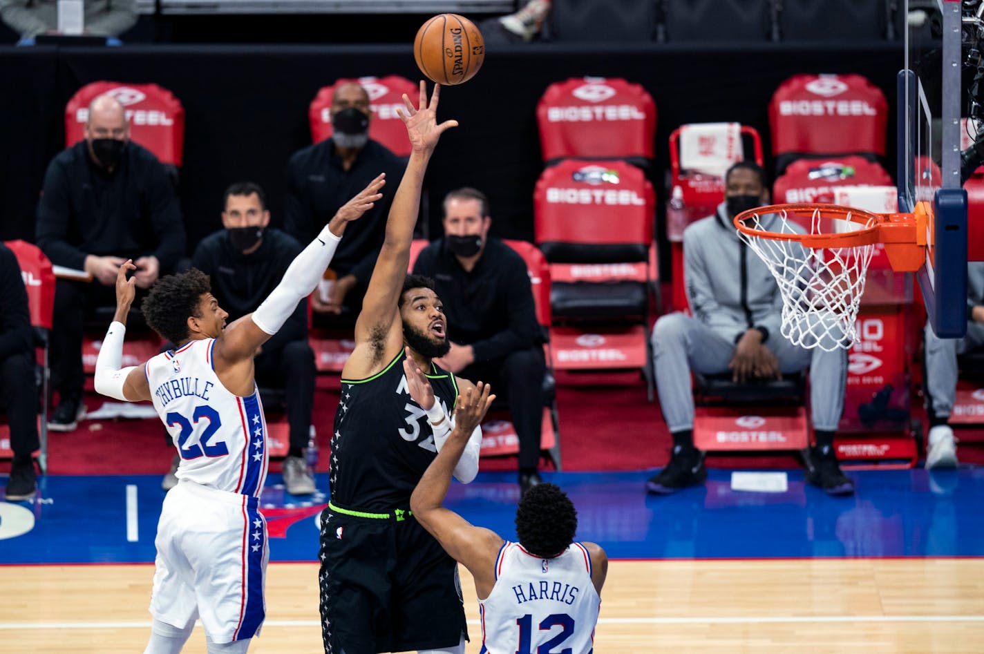 Timberwolves' Karl-Anthony Towns shoots between Philadelphia 76ers' Tobias Harris, right, and Matisse Thybulle during the first half