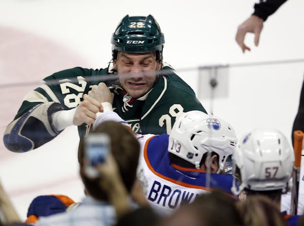 The game began with a fight in the opening seconds between the Edmonton Oilers Mike Brown (13) and the Minnesota Wild's Zenon Konopka (28) during firs