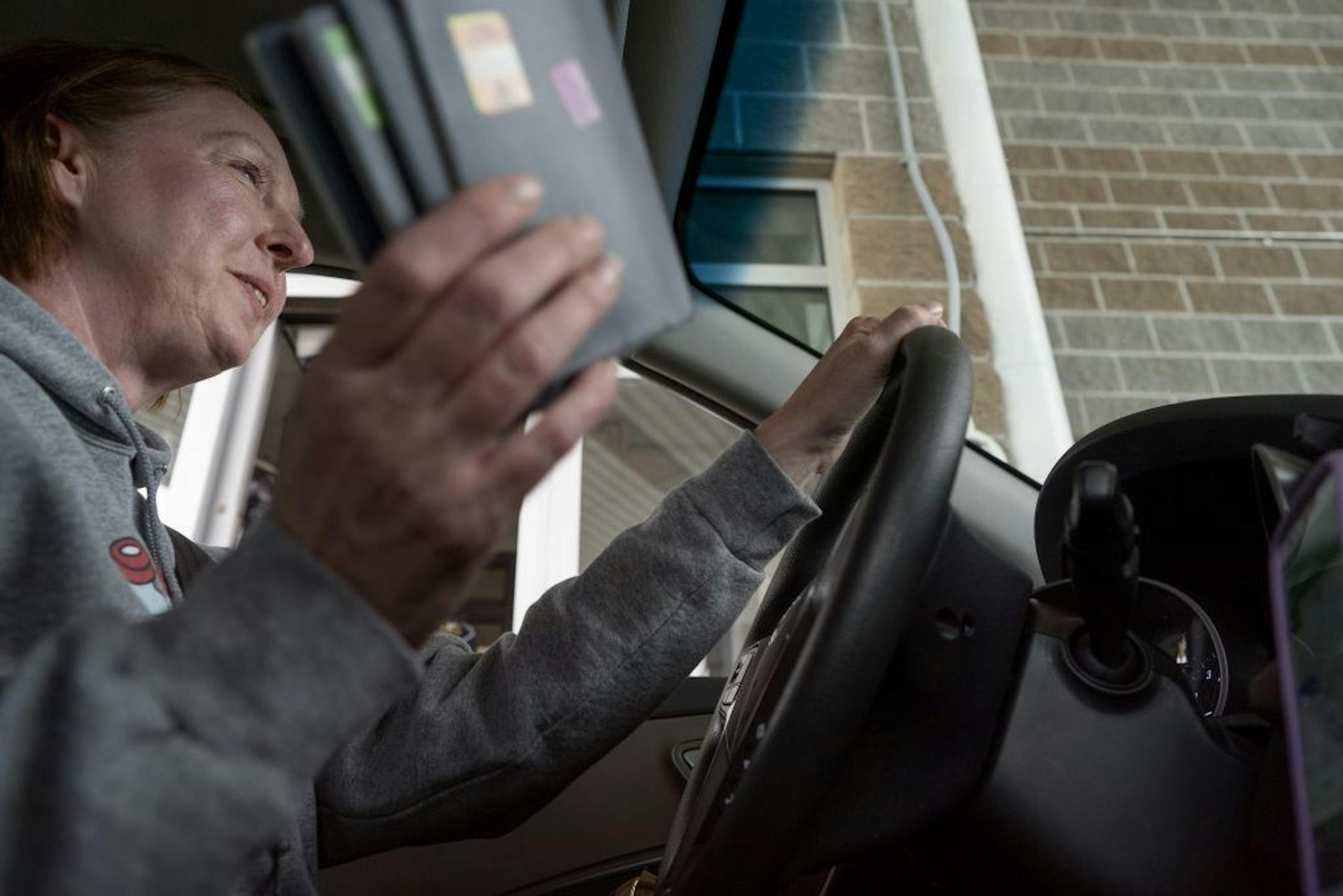 Nicole Smith-Holt gathered passports for the customs agent at the Canadian border in Ft. Frances Saturday May 4, 2019 in Ft. Frances, Ontario.