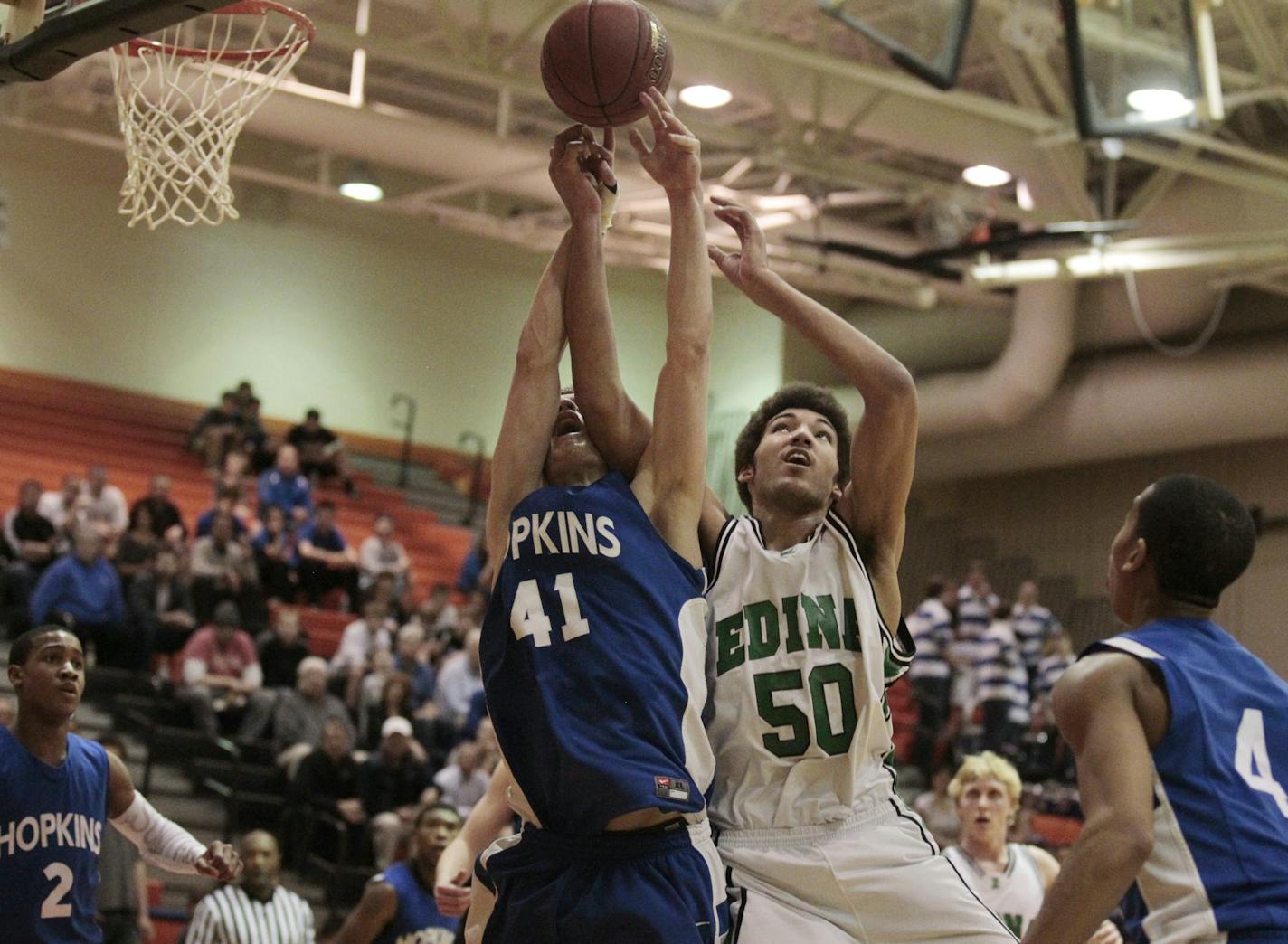 Nicholas Jorgensen of left of Hopkins battled Reggie Lynch of Edina for a rebound during class 4-A section final basketball action between Hopkins and Edina High School Tuesday March 13, 2012 in Osseo, MN. Hopkins beat Edina 69-55](Jerry Holt/ STAR TRIBUNE/jgholt@startribune.com) ORG XMIT: MIN2013030412451337