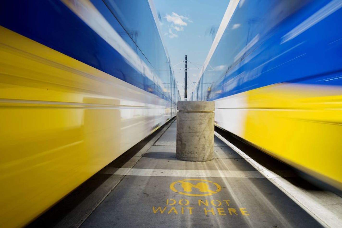 The light rail trains passed by one of the new pavement markings reading "do not wait here" at the intersection of University Av and Rice St in St. Paul, Minn. on Monday August 3, 2015.