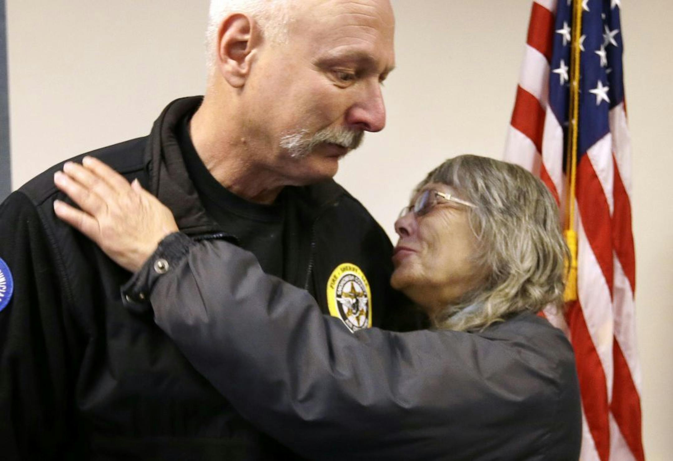 Robin Youngblood, right, smiles after embracing Snohomish County helicopter crew chief Randy Fay, who helped rescue her from the scene of a deadly mudslide days earlier, Wednesday, March 26, 2014, in Arlington, Wash.