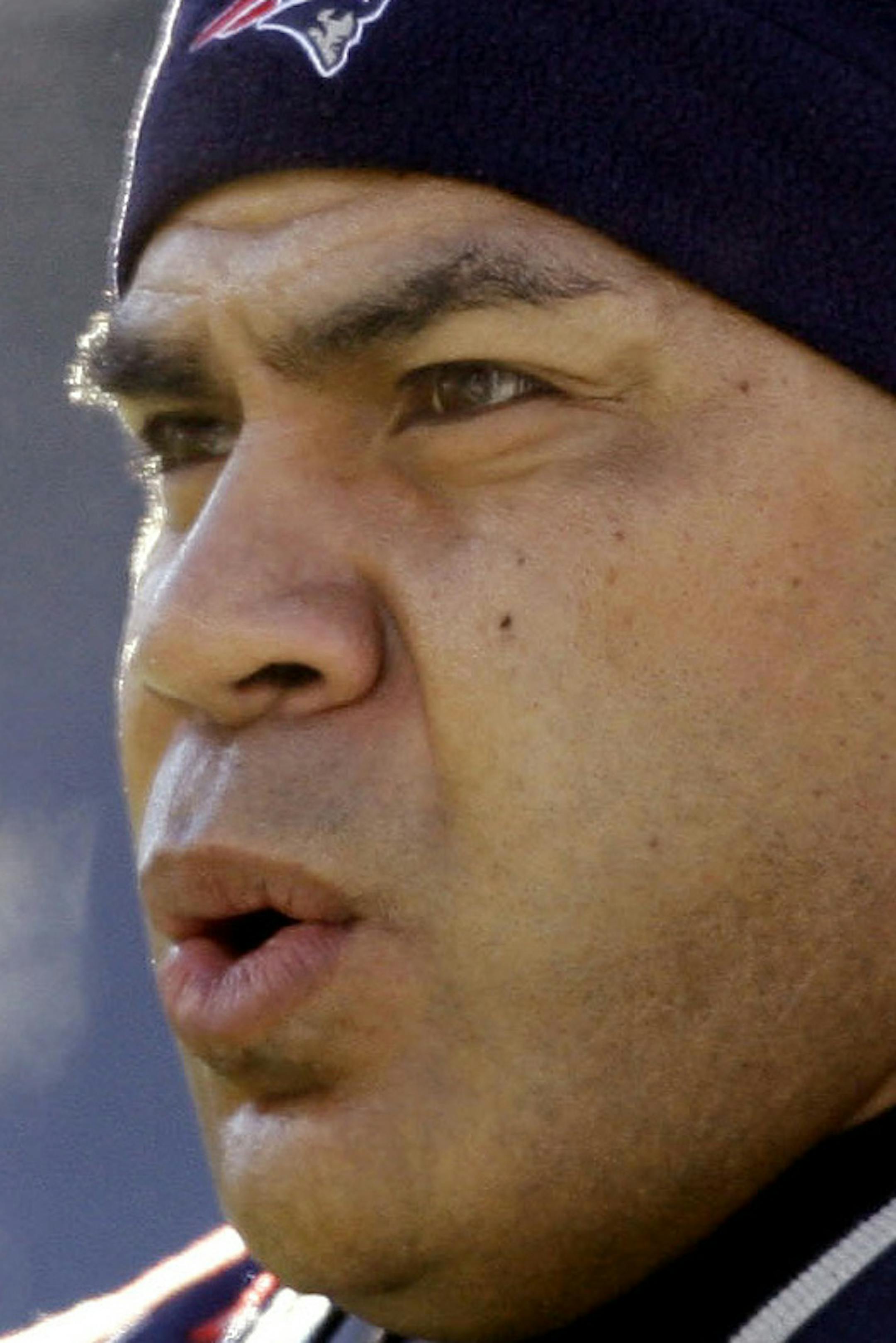 FILE - In this Jan. 10, 2010, file photo, New England Patriots linebacker Junior Seau warms up on the field before an NFL wild-card playoff football game in Foxborough, Mass. From perennial champion Charles Haley to the remarkably durable Mick Tingelhoff to the Bus, Jerome Bettis, the 2015 class of the Pro Football Hall of Fame is a versatile group. Missing for the Saturday, Aug. 8, 2015, inductions, however, will be linebacking great Seau, a suicide three years ago. (AP Photo/Charles Krupa, Fil