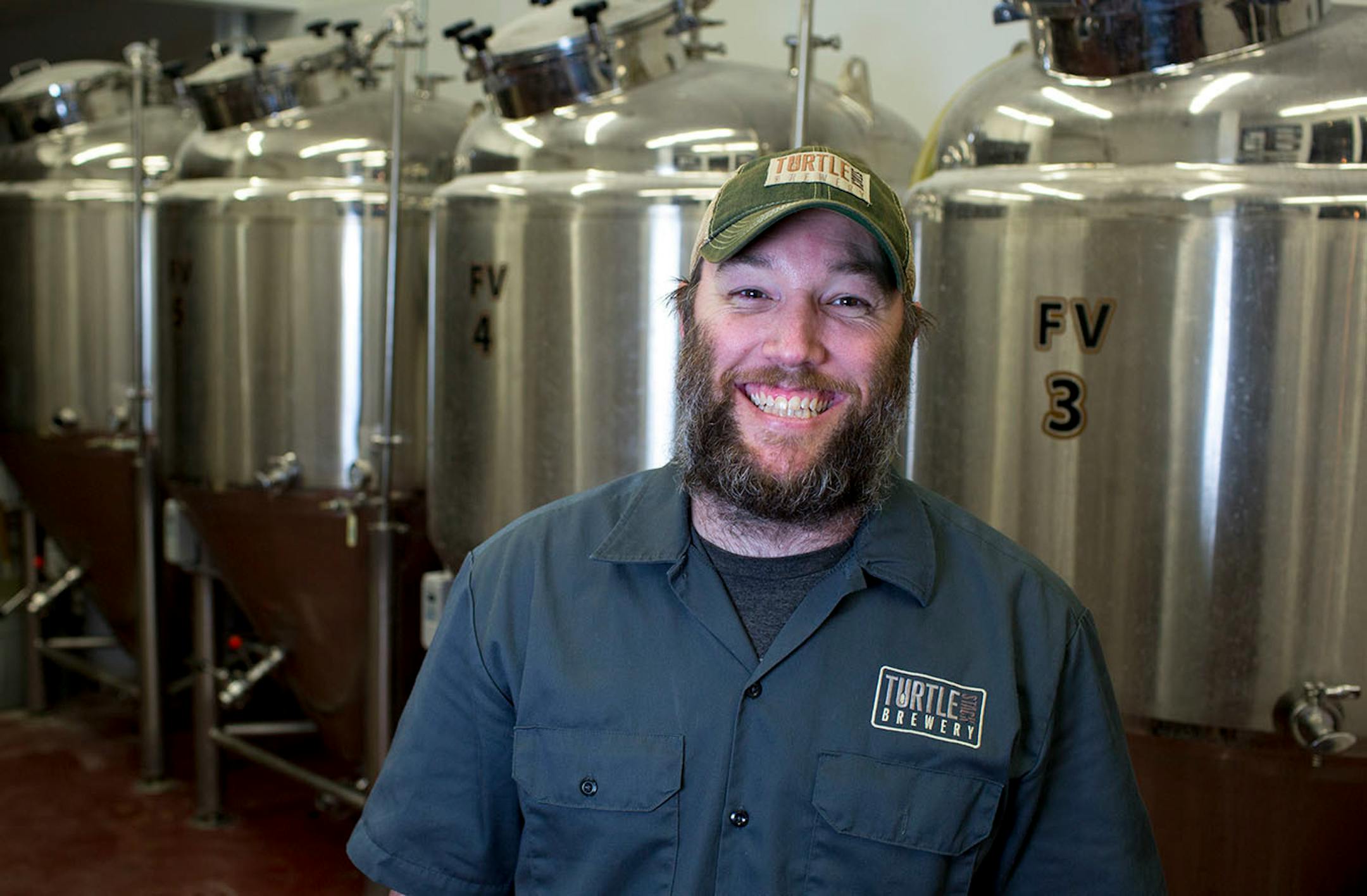 Turtle Stack Brewery brewmaster Brent Martinson poses for a portrait in front of the fermentation vessels which are visible from the bar. ] COURTNEY PEDROZA • courtney.pedroza@startribune.com June 22-24, 2017; Wisconsin restaurants, cafes, bars, bakeries and breweries; Dining along the Mississippi River.