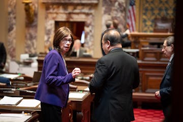 Sens. Kari Dziedzic and Foung Hawj talk on the Senate floor.