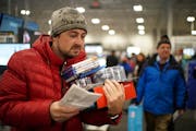 Andrew Kropp checked his list as he stocked up on movies, among other items, shortly after Best Buy in Eden Prairie opened on Thanksgiving evening in 