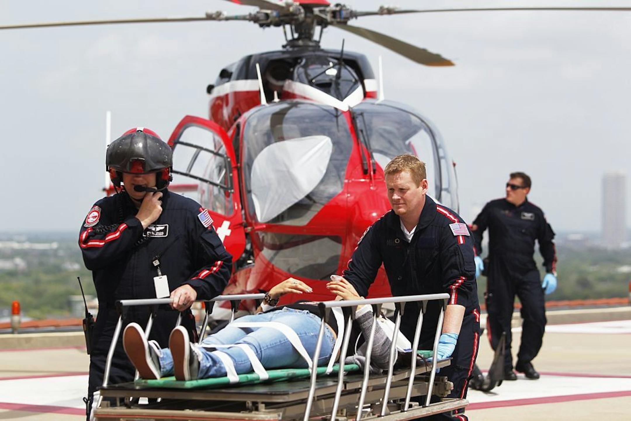 Life Flight personnel rush a victim wounded in a stabbing attack on the Lone Star community college system's Cypress, Texas campus into Memorial Hermann Hospital Tuesday, April 9, 2013, in Houston. The Harris County Sheriff's department confirmed at least 11 people wounded and that authorities have one suspect in custody.