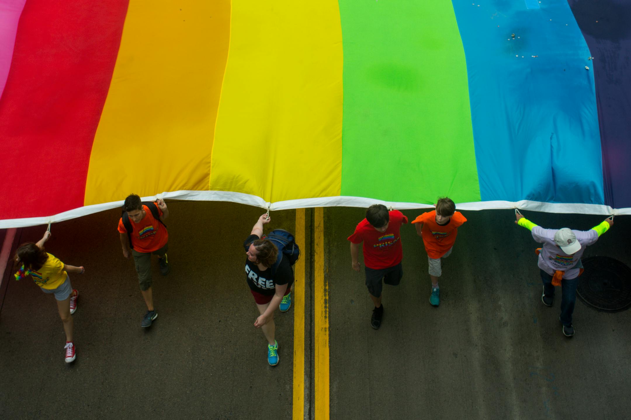 Prism Campus Alliance, a group out of Saint Paul College, marches with a gay pride flag. ] NICOLE NERI &#xa5; nicole.neri@startribune.com
BACKGROUND INFORMATION: Sunday June 23, 2019 at the Minneapolis Pride Parade, starting at 2nd Avenue and 3rd Street and ending at Loring Park.