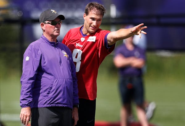 Minnesota Vikings head coach Mike Zimmer left and quarterback Kirk Cousins (8) went over a play during Minnesota Vikings training camp at TCO Performa