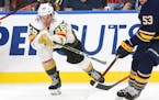 Vegas Golden Knights forward Erik Haula (56) reaches for the puck during the third period of an NHL hockey game against the Buffalo Sabres, Monday, Oc