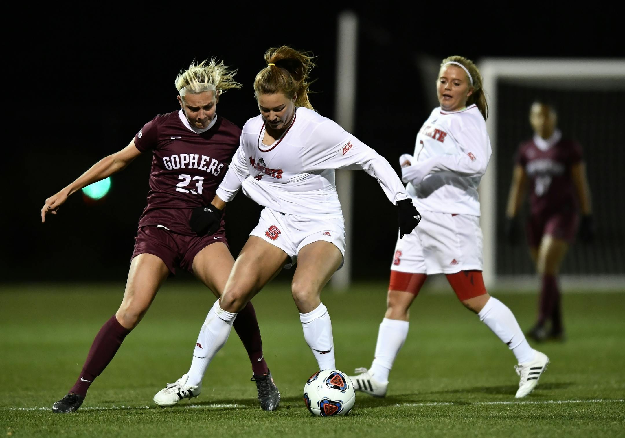 Minnesota forward Julianna Gernes (23) grabbed the jersey of NC State midefielder Hannah Keogh (4) in the first half Saturday.