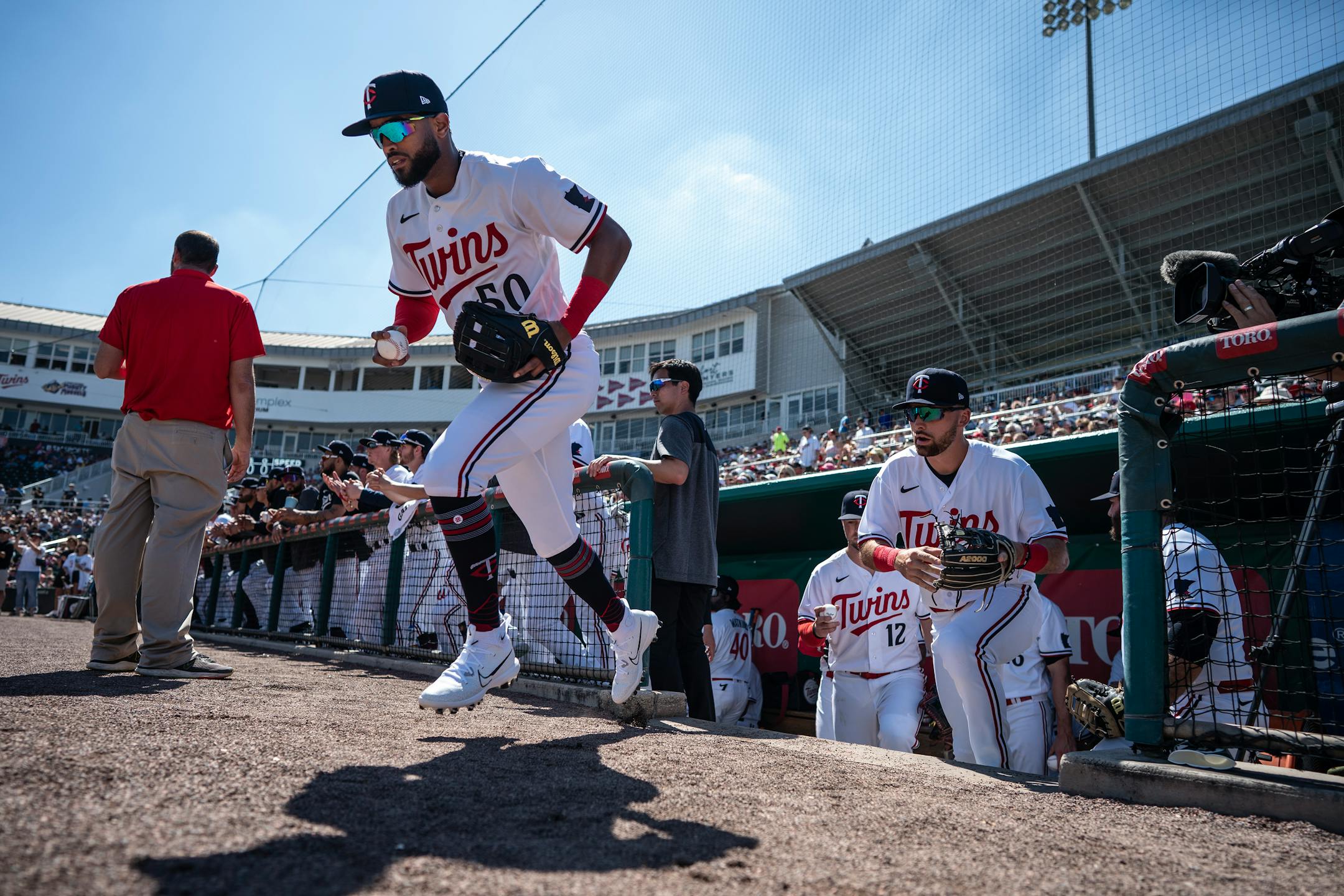 Minnesota Twins Willi Castro (50) third baseman leads the team out of the dugout for the first time of the Spring Training games vs the Tampa Bay Rays.