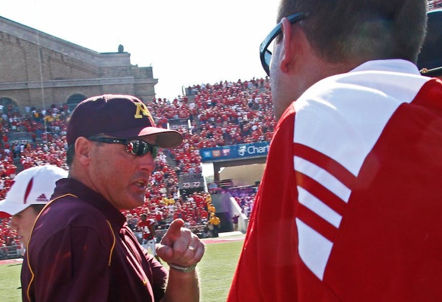 ]MARLIN LEVISON * mlevison@startribune.com October 9, 2010 - GENERAL INFORMATION: University of Minnesota vs. Wisconsin football. Wisconsin won 41-23. IN THIS PHOTO: Minnesota head coach Tim Brewster, left was "not happy" as he made the traditional mid-field shaking of hands with the opposing coach - Wisconsin head coach Bret Bielema. Brewster told Bielema that going for two points conversion after a touchdown with a huge lead in the 4th quarter was not necessary and that "the Gophers would be back".