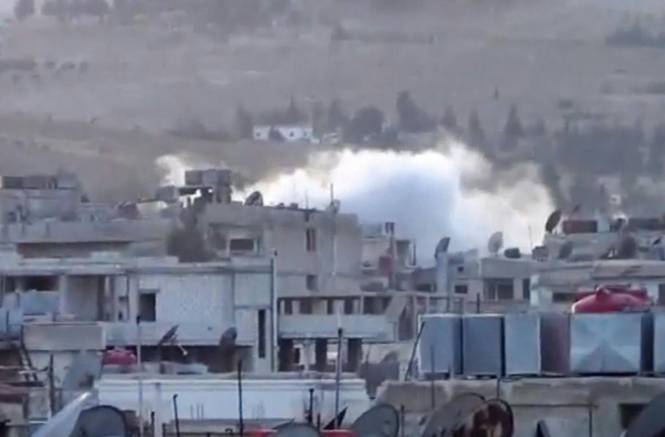 In this image taken from video obtained from the Shaam News Network, smoke rises from buildings due to artillery bombardment on the outskirts of Damascus, Syria, Thursday, Sept. 5, 2013.