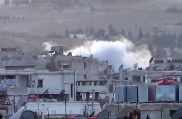 In this image taken from video obtained from the Shaam News Network, smoke rises from buildings due to artillery bombardment on the outskirts of Damas